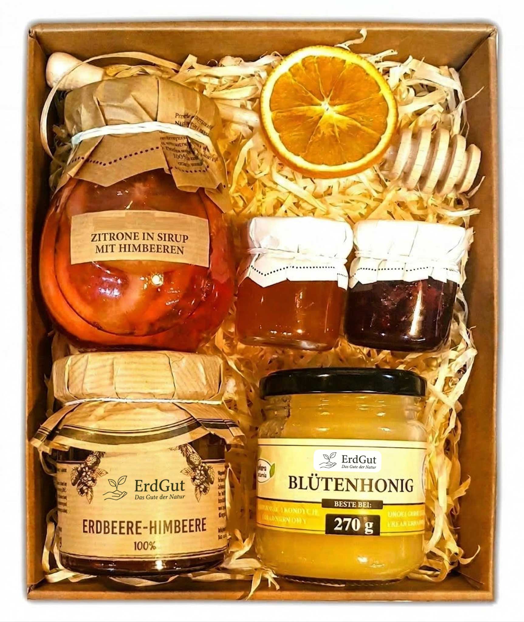 Geschenkkorb mit Honig, Konfitüre und Zitronen in Sirup